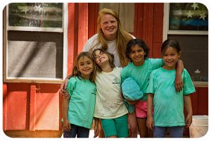 A cabin of four first-year campers pose with their counselor. 